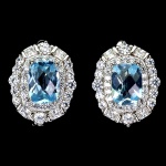 Belíssimo par de brincos em prata de lei espessurada a ouro branco, design exclusivo de excepcional ourivesaria com precioso Topázio Sky Blue de 7.0 x 5.0 mm, clássica lapidação almofada brilhante, adornado por rico trabalho e majestosas coroas de Zirconias de lapidações princess e diamante. Perfeito estado de conservação, sem uso. Medem 1,4 x 1,2 cm. Origem África.