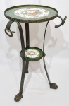 EXCLUSIVA MESA AUXILIAR FINAMENTE EXECUTADA EM METAL PATINADO DE EXCELENTE FUNDIÇÃO, ELEVADADA SOBRE ELEGANTES PÉS NO FORMATO DE GARRA E FINO ACABAMENTO COM TAMPOS EM PORCELANA DECORADOS COM BELÍSSIMA ORNAMENTAÇÃO FLORAL. BRASIL INICIO DO SÉCULO XX. EXCECELENTE ESTADO DE CONSERVAÇÃO. MEDE APROX 60 CM DE ALTURA X 34 CM DE DIÂMETRO DO TAMPO SUPERIOR.