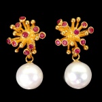 Belo par de brincos em prata espessurada a ouro amarelo, design moderno exclusivo de excepcional ourivesaria com linda Pérola de 8.0 mm, adornada por rico trabalho e fino acabamento com rubis de lapidação brilhante. Perfeito estado de conservação, sem uso. Medem aprox 2,2 x 1,4 cm. origem Tailândia e África.