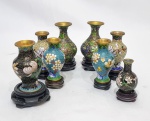 CLOISONNÉ, JAPÃO - Lindo e clássico lote composto por 8 vasos em metal esmaltado Closoinné de ótima fundição, adornados por ricas tonalidades e motivos florais. Apoiados sobre base de madeira. Bom estado de conservação, maior mede 10,0 cm de altura. São 3 pares e 1 pandam.