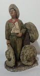 Escultura em cerâmica representado vendedor de sombreiro. Restauro no pescoço -  21 cm altura