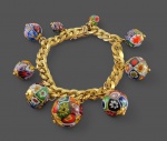 Pulseira em ouro amarelo 14 k  com balangandãns em contas de murano . Peso total . 65,2 gr Med. 17 cm