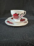 Colclough Bone China.conjunto de chá Colclough Bone China, composto por uma xícara, um pires e um prato de sobremesa, decorados com rosas vermelhas e detalhes dourados. Este conjunto específico é conhecido por suas rosas vermelhas e brancas. A Colclough China foi fundada em 1890 por Herbert Joseph Colclough, e em 1913 recebeu a licença real para produzir a Royal Vale china. A empresa se destacou como uma grande fabricante de conjuntos de chá de porcelana na Grã-Bretanha.Como se encontra nas fotos.  