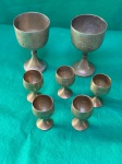 Conjunto de 7 copos em metal, composto por 2 copos grandes e 5 miniatura de copos. Os dois copos maiores medem 7 cm de altura.