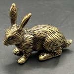Miniatura representando coelho, feito em cobre, rico em detalhes. Medidas: Altura 3 cm x Largura 1 cm x Profundidade 3,5 cm.