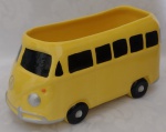 Escultura representando Kombi em faiança na cor amarela vitrificada, pode ser usado como floreira. Medindo 22 x 9 x 12 cm.