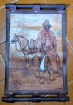 Pintura com intervenções piro gráficas com policromia assinadas "Del Punto" trabalho regional dos pampas Argentinos medindo 58 cm por 38 cm.