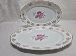Jogo de 2 travessas ovais em porcelana Steatita floral com friso ouro. Medindo a maior 36cm x 24cm. Friso com desgaste.
