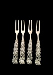 Conjunto com 4 garfos para petisco em metal espessurado a prata, cabo decorado em parreiras. Med.: 14 cm