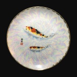 Belo e robusto prato em porcelana oriental, decorado com carpas policromadas. Superfície com efeito furta-cor. Dimensões: 3,5 cm x 31 cm.