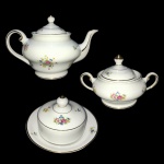 BARÃO DO RIO BRANCO - Conjunto com bule, açucareiro e mantegueira de porcelana esmaltada decorado com arranjos florais e filetes pintados à ouro. Dimensões:16 cm x 26 cm (maior peça).