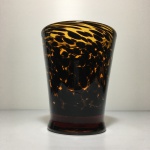 Vaso em pasta de vidro âmbar com detalhes profusos na cor preto. Dimensões: 12 cm x 10 cm.