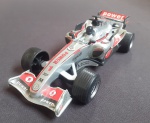 Carrinho de Plástico Miniatura Simbolizando Carro de Corrida 15cm.