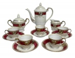 Gracioso serviço para café em porcelana japonesa composto de bule, açucareiro, leiteira e cinco xícaras com os seus respectivos pires, adornados com volutas e arabescos em vibrante ouro sobre fundo magenta. Bule com sinal de pequeno restauro. Possui registro na base. Medida do maior 21cm.