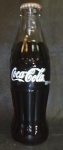 Colecionismo - Garrafa de Coca-cola antiga sem uso com 237ml, tampinha apresenta ferrugem. Alt. 19cm