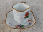 França /LIMOGES -  W.Guerin&C .  Linda xícara com pires de porcelana francesa , formato levemente quadrado , ramos de flores em fundo branco. Pega e borda  tanto da xícara como do pires cobertos de ouro . Circa de 1900. MONOGRAMADA .Altura 6 cm.