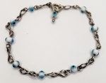 Pulseira produzida em prata de lei, corrente miodelo simbolo infinito, com ornamnetação de olhos gregos, comprimento aberto:18cm.