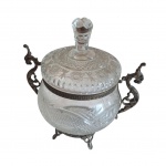 Antiga bombonière em cristal europeu lapidado, guarnições em cobre, par de asas representando dragão, apoiado em pernas recurvas, Alt. 28, Diam. 19 cm.