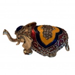 Escultórico  articuladorepresentando elefante em metal dourado, corpo esmaltado e com strass  com algumas falhas nas pedrarias,  Com 12, Larg. 5, Alt. 6 cm.