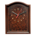 Relógio de parede em madeira com moldura retangular realçada por frisos canelados e frontão arqueado. Mostrador em rádica com 2 ponteiros pretos e um vermelho, e numerais dourados. Funcionamento a pilha. Artesanato Barracão. 27 x 21 x 4 cm.