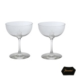 BACCARAT - Par de taças para champanhe em cristal francês translucido. Bojo liso com iniciais entrelaçadas.  Base circular 11 cm.