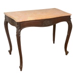 Mesa de centro em madeira nobre, esculpida e ornada por adornos fitomórficos. Tampo em mármore bege mesclado, de formato retangular com laterais recurvas. Caixa acompanhando o movimento. Saia ondulada centralizando composição floral. Pernas curvilíneas com joelhos salientes e recamados por folhagens. Pés revirados em volutas, apoiados em sapatas. 80 x 100 x 50 cm.