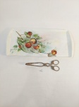TRAVESSA PARA PETISCO/RACANBOLE EM PORCELANA SCHMIDT COM DECORAÇÃO DE FRUTAS PINTADO Á MÃO MARCARDO RACHEL COM PEGADOR EM METAL RICAMENTE TRABALHADO.MEDIDA: 41 CM X 19,5 CM DE LARGURA, PEGADOR 19 CM DE COMPRIMENTO