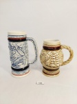 2 CANECAS PARA CHOPP EM CERÂMICA  CERAMARTE RICAMENTE DECORADAS EM ALTO RELEVO SENDO 1 COM AVIÕES E OUTRA COM NAVIO. MEDIDA: MAIOR 5 CM X 13,5 CM DE ALTURA , MENOR 4,5 CM D X 11 CM DE ALTURA