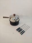 CONJUNTO PARA FONDUE EM INOX COMPOSTO POR 1 PANELA, 1 RÉCHAUD E  6 GARFOS PARA FONDUE, APRESENTA MARCAS DO TEMPO. MEDIDA: 16 CM D X 20  CM DE ALTURA X 31 CM DE COMPRIMENTO, GARFOS 24,5 CM DE COMPRIMENTO