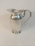 JARRA PARA ÁGUA/SUCO EM PRATA EBERLE COM DETALHES GRAVADOS E ALÇA TRABALHADA. MEDIDA: 14,5 CM X 12,5 CM X 21 CM DE ALTURA.