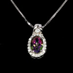 Belíssimo colar em prata de lei espessurada a ouro branco, design exclusivo de excepcional ourivesaria. Pingente com precioso Topázio místico extra de 7.0 x 5.0 mm, clássica lapidação oval brilhante, adornado por rico trabalho e fino acabamento com majestosa guirlanda de Zirconias extra brancas de lapidação brilhante. Perfeito estado de conservação, sem uso. Corrente com clássica malha veneziana, mede 45 cm, pingente 1,8 x 0,8 cm. Origem África e Brasil.