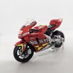 Miniatura moto Honda RC211V 2006, cor vermelho, modelo pilotado por Marco Melandri, mede aproximadamente 11x6 (sem caixa).