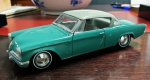 Miniatura Studebaker Starliner de 1953, cor verde, mede aproximadamente 28x08 (sem caixa).