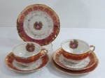 ROYAL BONE FINE CHINA  22kt gold- Par de ternos em porcelana na cor branca, decorado ao centro com cena galante, borda recortada com faixa bordô com farta douração a ouro em guirlandas,.Composto: duas xícaras para chá com pires ( 12 cm) e dois pratos para bolo ( 15,5 cm) . Marcado na base.  Apresenta alguns desgastes na douração.