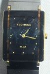 TECHNOS (Black) - Elegante relógio de pulso modelo feminino, a quartz, no estilo Arte Deco, com caixa em plaquedor e pulseira em aço. Funcionando no momento e sem garantias futuras. Med 3,5 cm (Caixa). Não garantimos autenticidade, pois não abrimos a maquina.