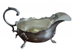 Antiga molheira em metal espessurada a prata, encimada por três pés, com seu corpo liso, pés e pegador em forma de ramos,  bordas finamente em ondulações  Med:11x19,7x9,5cm.