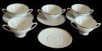 SCHMIDT -  Lote contendo nove peças, sendo cinco consommê, e quatro pires, confeccionado em porcelana branca esmaltada, com rica decoração em frisos prateado. Med: 7 X 11,5 CM , Medida do prato16 CM.