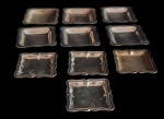 Lote de dez peças confeccionada em metal, com as bordas decoradas em arabescos relevo,  de tamanhos e formatos diferentes. Med: 8x8 / 7x7cm.