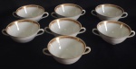 BRENNAND - " RECIFE - BRASIL" - Lote contendo sete consume em porcelana branca, com rica decoração de frisos dourados.  (  OBS:.  um está com alça quebrada e colada). Med: 5 x 15cm.