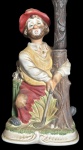 MELODY IN MOTION - Antiga escultura em porcelana de origem japonesa representando curioso Palhaço jogador de golfe segurando relógio em formato de árvore , assinado no verso Seiji Nakame manufatura Melody In Motion .  Med :40x12x16cm. (Obs.: Não testado)