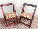 Elegante e antigo par de cadeiras, no estilo arte deco, anos 70, articuláveis, em madeira nobre, com encosto vazado, assento em tecido decorado por palmas.