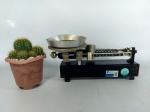 BALANÇA - ANTIGA: Antiga balança de mesa da marca Agram toda em ferro, carga máxima de 1050g. Medidas: altura: 15 cm, largura: 13 cm e comprimento: 30 cm.