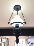 Antiga luminária em metal com partes em resina na cor preta,com cúpula em vidro. Dimensões: 65 cm com a corrente.. Retirada somente por transportadora feito pelo arrematante