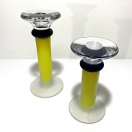 Par de castiçais de vidro nas cores azul e amarelo com partes foscas e translúcidas. Dimensões: 17 cm (maior peça).
