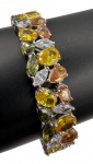 Pulseira em prata de lei cravejada por zircônias amarelas, brancas, laranjas e verdes. Comprimento: 19cm Largura: 1,2cmmm