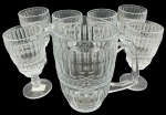 Lote composto por seis taças e jarra em demi cristal decorado por bolinhas e frisos. Altura da taças: 17cm Altura da jarra: 20cm