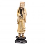 Escultura de marfim policromado, representando figura masculina oriental. Base de madeira. Altura: 14,7cm