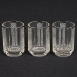 CRISTAL, três (3) copos Art Deco para licor, facetados, incolores e translúcidos, detalhes em satinê e esmalte na tonalidade preta, medindo 5 cm altura, vide foto.