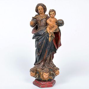 Belíssima imagem de <b>Nossa Senhora do Rosário</b>. Vigorosa talha das vestes em pregueados espraiados aos pés e pano de cabeça movimentado. À mão esquerda, apoia-se o Menino com a esfera armilar. Policromia íntegra. A Santa pousa sobre enrolados de nuvens com três cabeças de anjo ressaltadas. Base chanfrada na cor carmim. Séc. XVIII. Alt. 19 cm