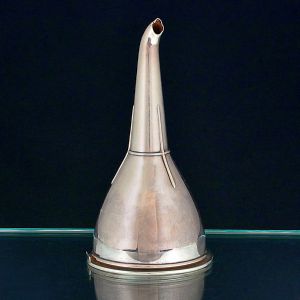 "<b>Wine funnel</b>" em prata inglesa lisa, de formato cônico e bico recurvo. Parte interna com peneira. Contrastes da cidade de Sheffield do período georgeano e marca do prateiro Alexander Goodman & Co registrado em 1805. Compr. 15,5 cm